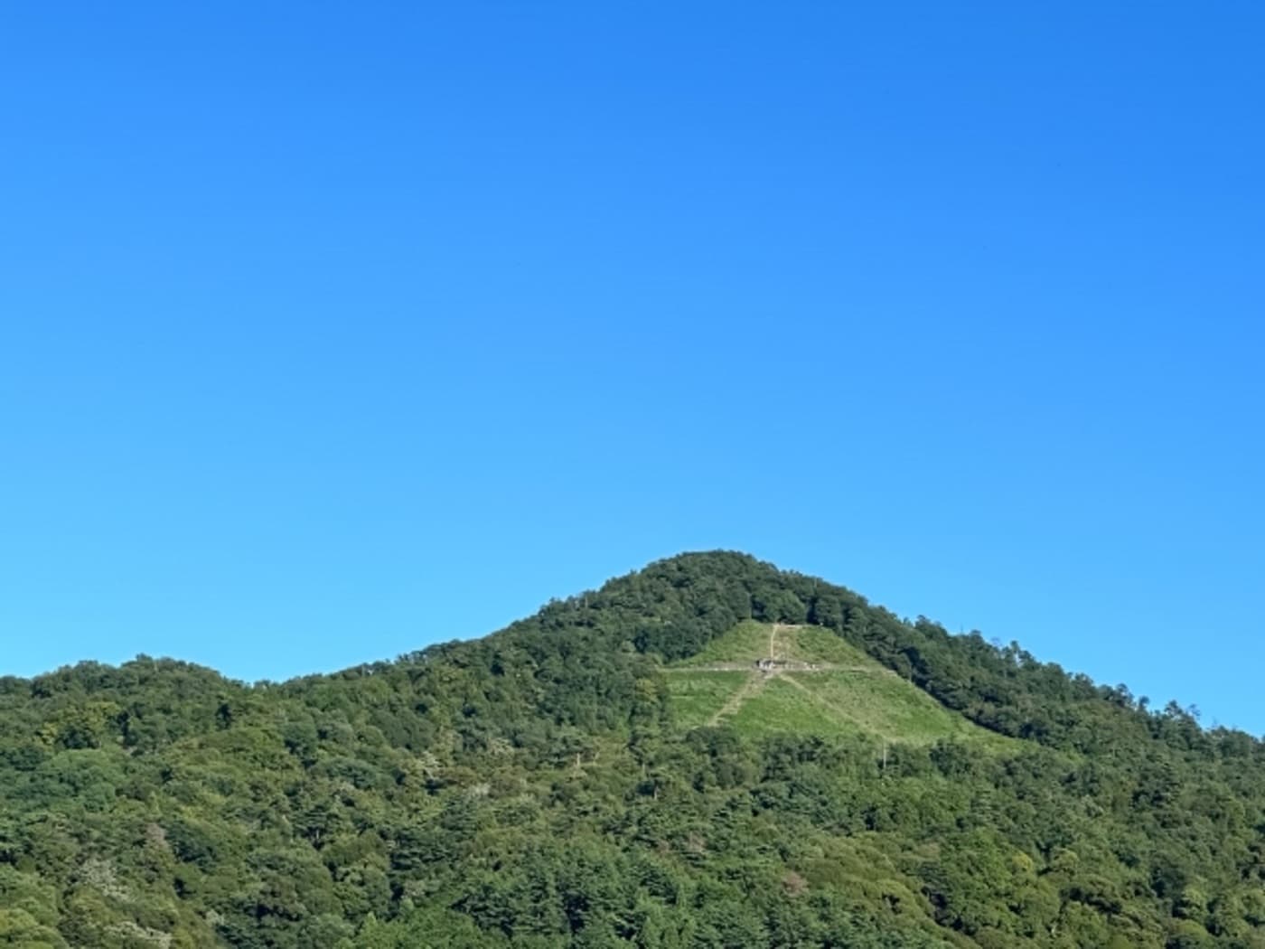 The Daimonji firebed on Nyoigatake seen by day, the giant kanji character carved into the green mountainside above Kyoto