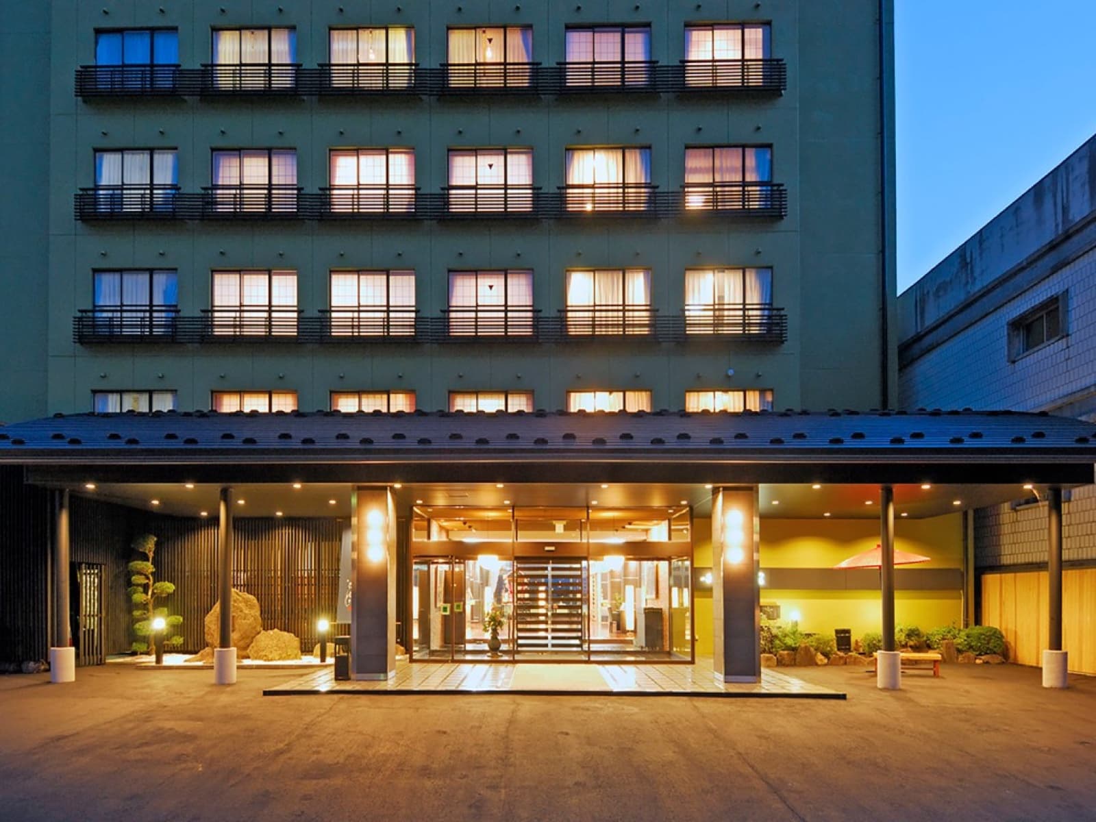 An onsen hotel in Nagano at dusk — the kind of mountain-town property affected by the new 2026 prefectural lodging tax
