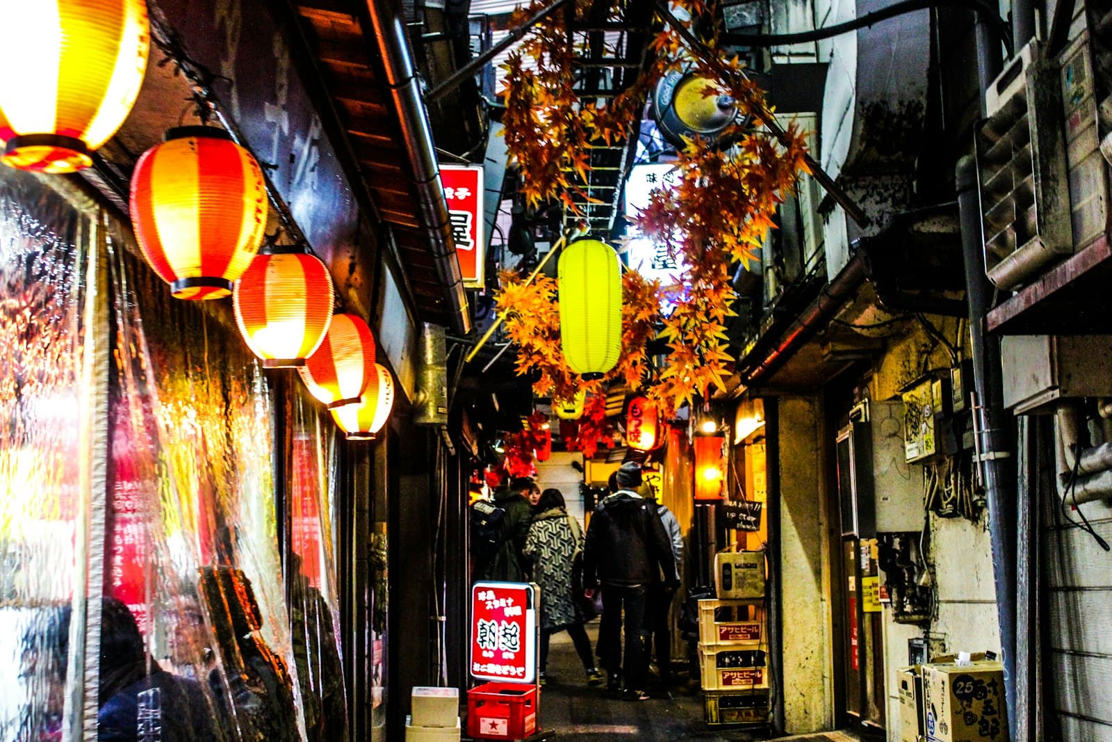 Izakaya alley in Shinjuku Tokyo with warm restaurant lights