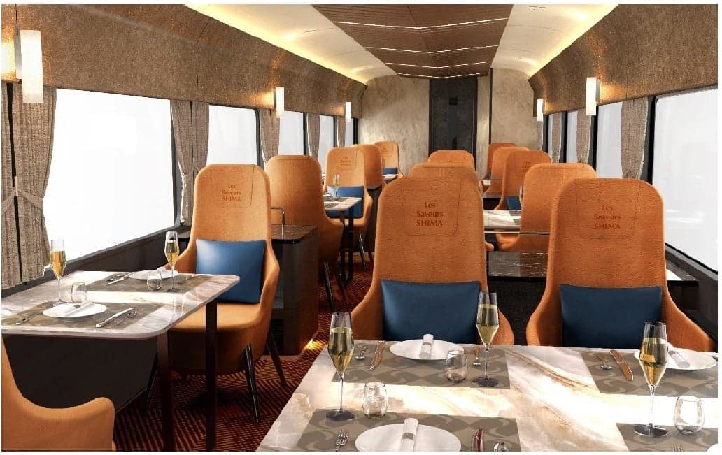 Rendering of car 4 of Les Saveurs Shima: tan leather armchairs with blue cushions at marble-topped tables set with glasses and cutlery