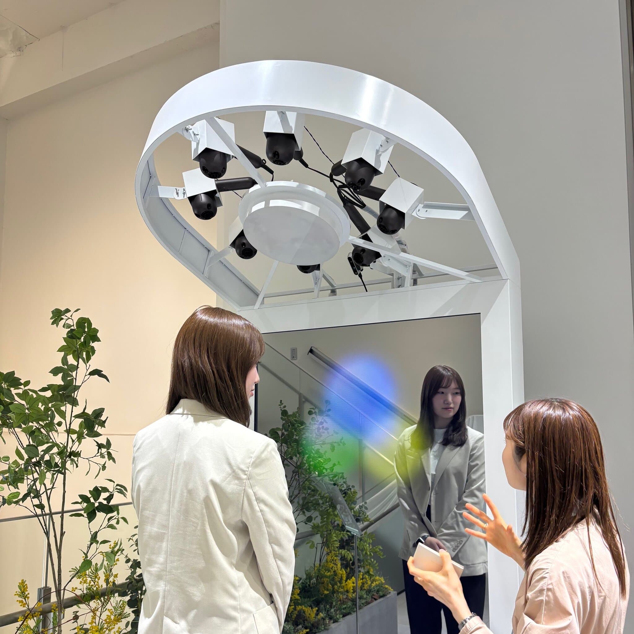 A guest standing under eight Panasonic premium hair dryers releasing nano ions