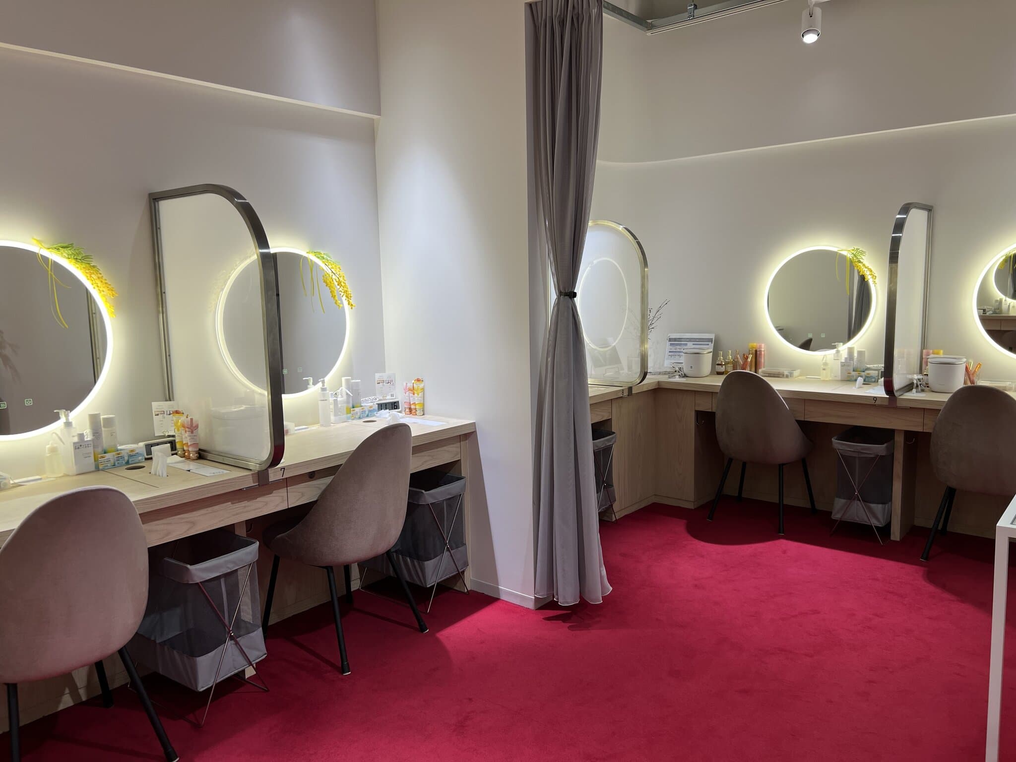 A private free trial booth with a vanity table and Panasonic devices