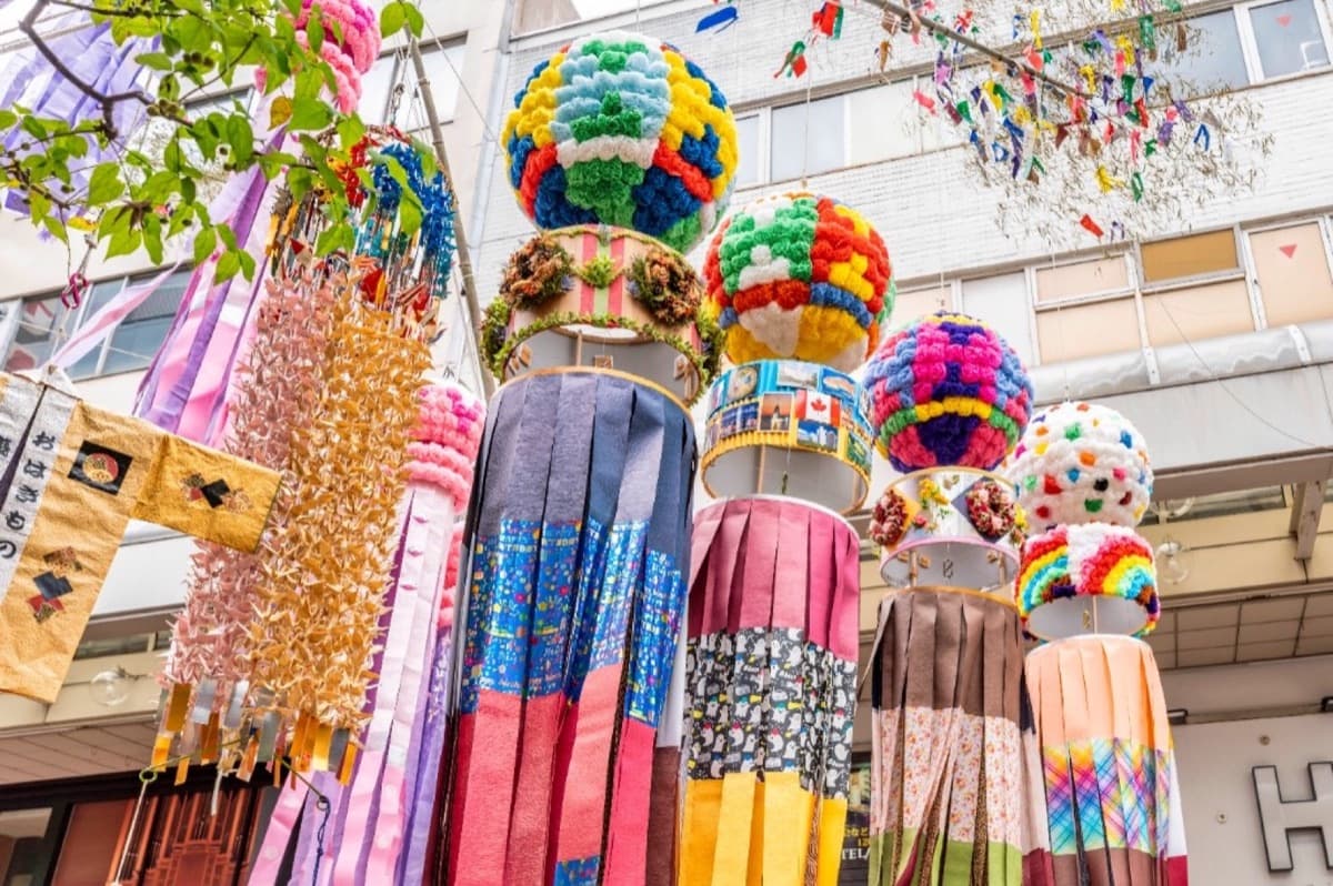 Colorful sasakazari paper streamers and kusudama balls hanging from bamboo poles during Sendai Tanabata Matsuri