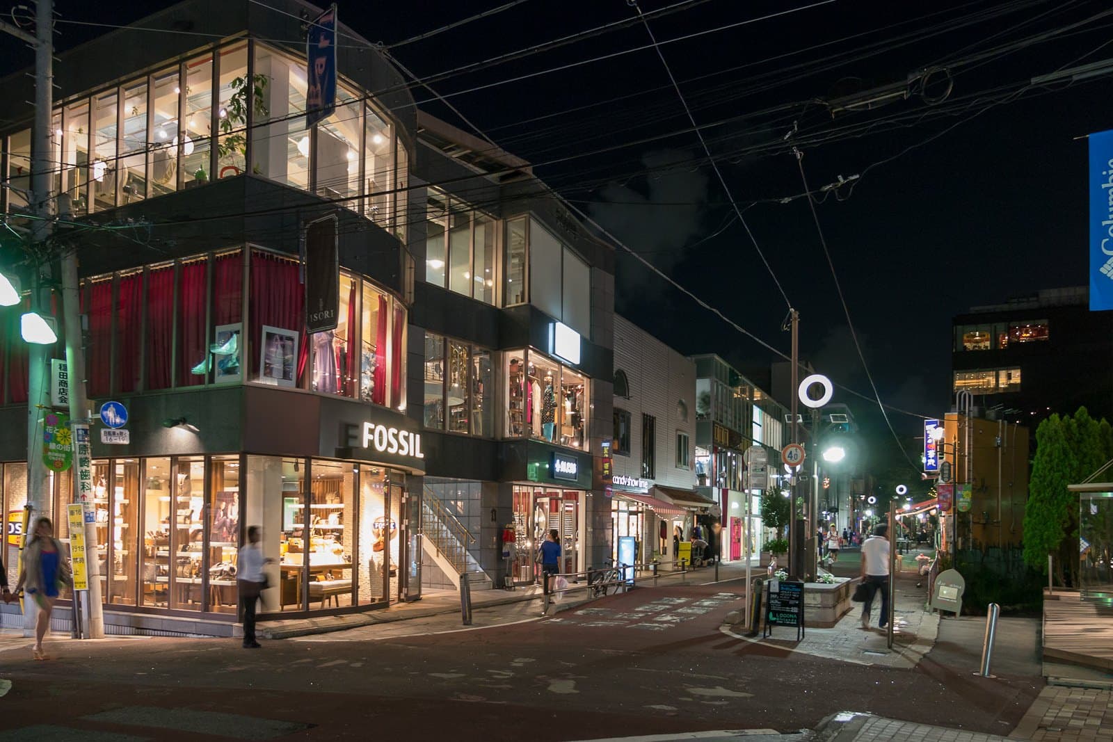 Boutiques with lit windows along Cat Street between Harajuku and Shibuya at night