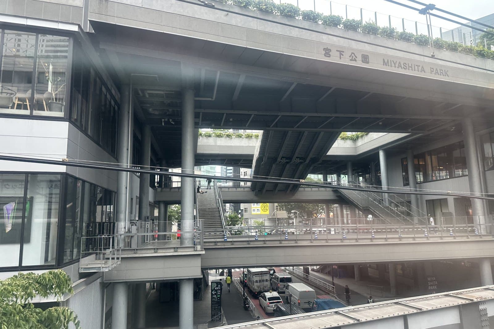 The long MIYASHITA PARK building with walkways and a rooftop park running beside Meiji-dori in Shibuya