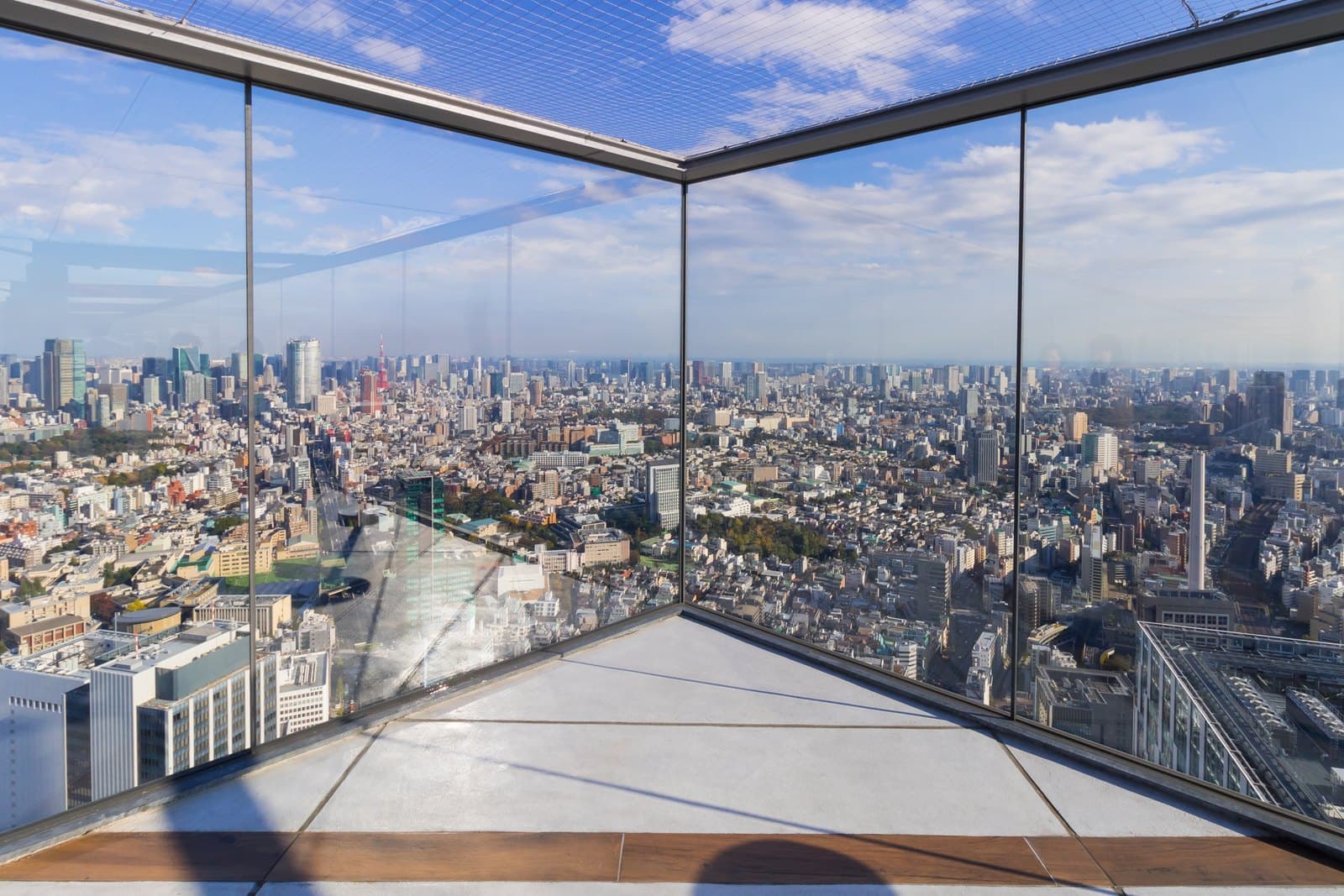 The glass-walled corner of the Shibuya Sky rooftop with central Tokyo, Roppongi and Tokyo Tower beyond