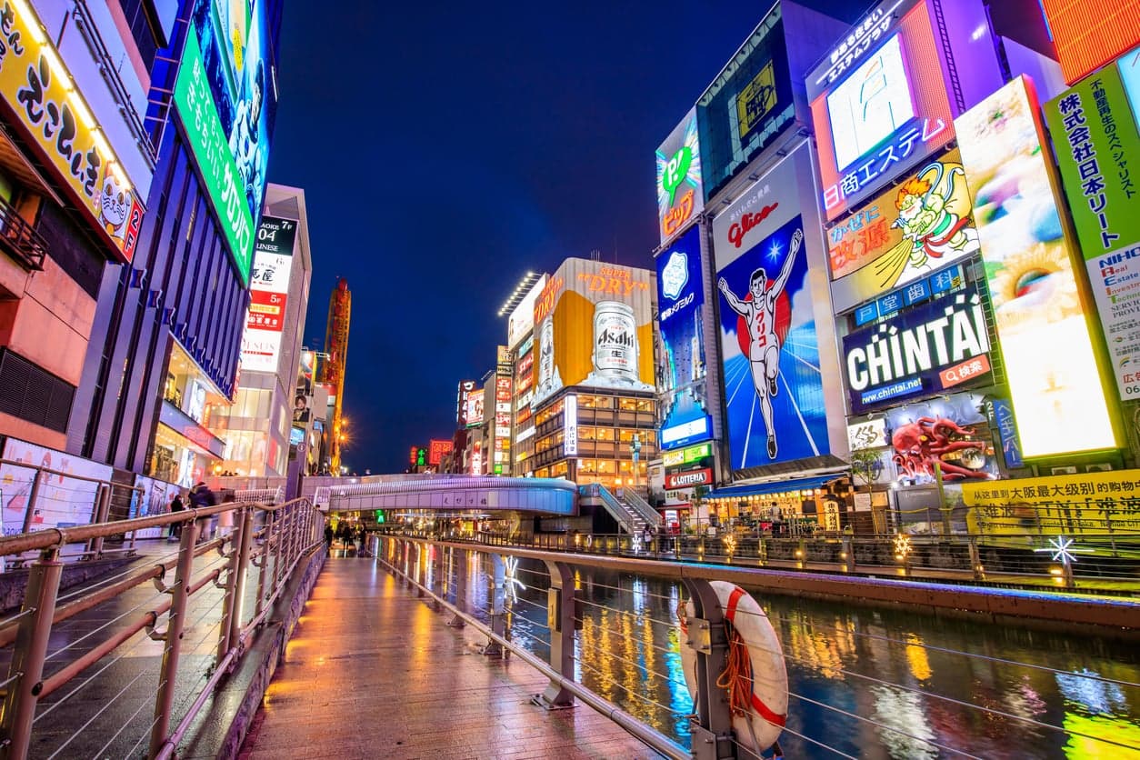 Neon signs reflected in the Dotonbori canal in Osaka at night