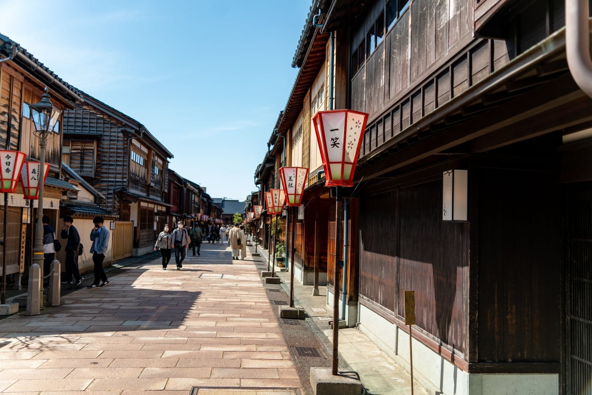 The main street of Higashi Chaya lined with two-story wooden teahouses with latticed fronts
