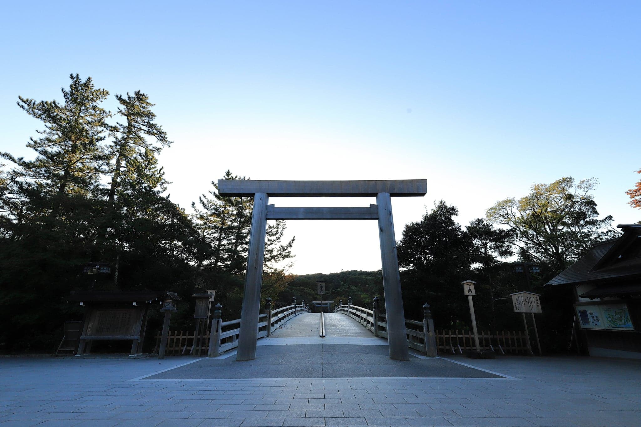 The wooden torii and Uji Bridge at the entrance to Ise Grand Shrine at dawn
