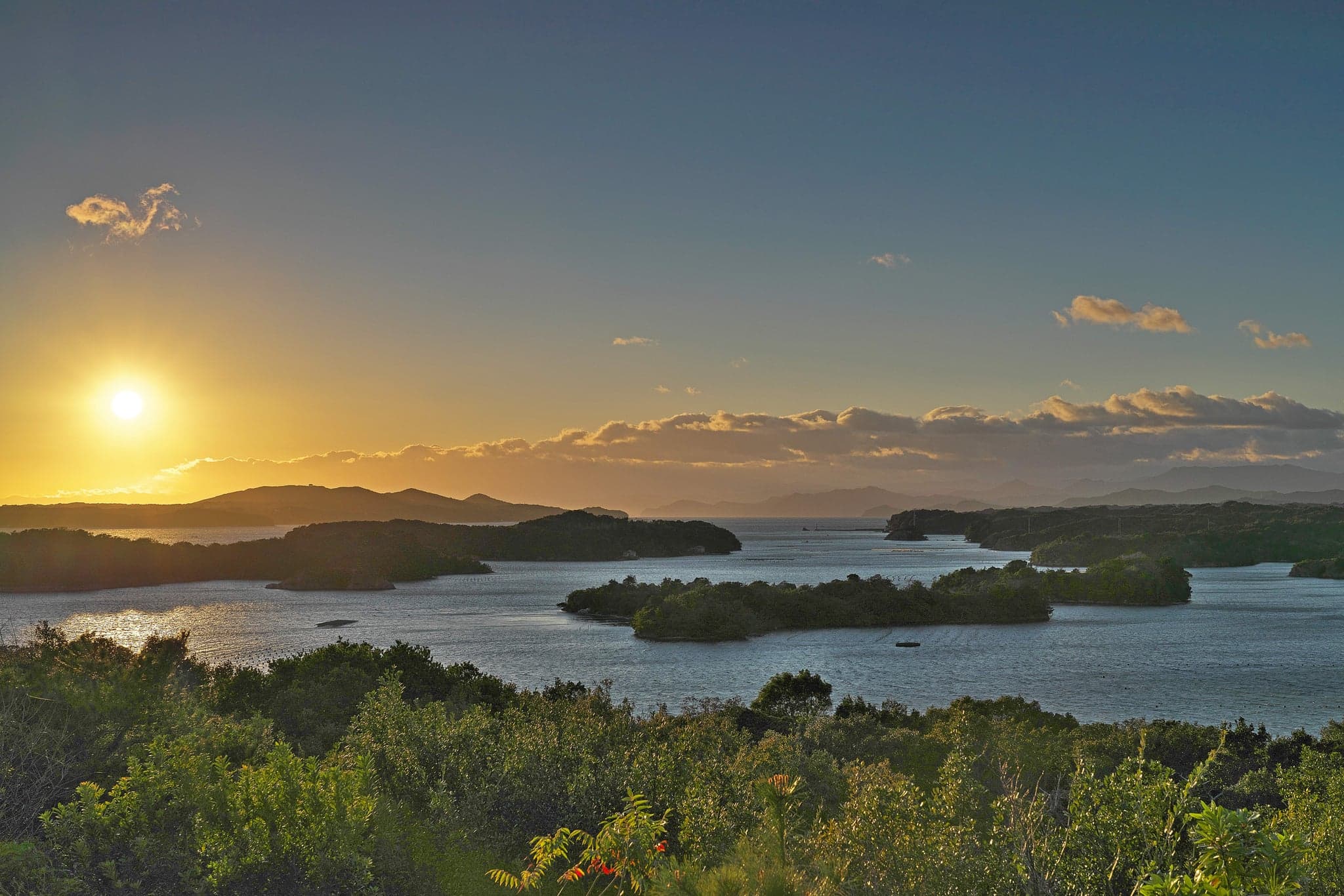 Wooded islands scattered across Ago Bay at sunset near Kashikojima in Ise-Shima