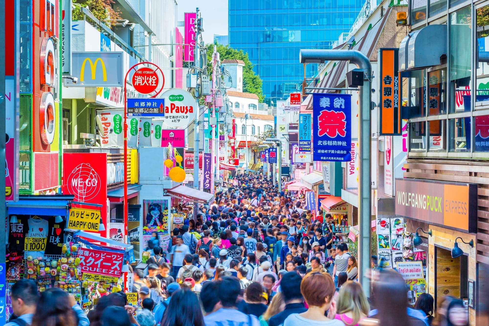 Takeshita Street in Harajuku packed with shoppers under colorful shop signs