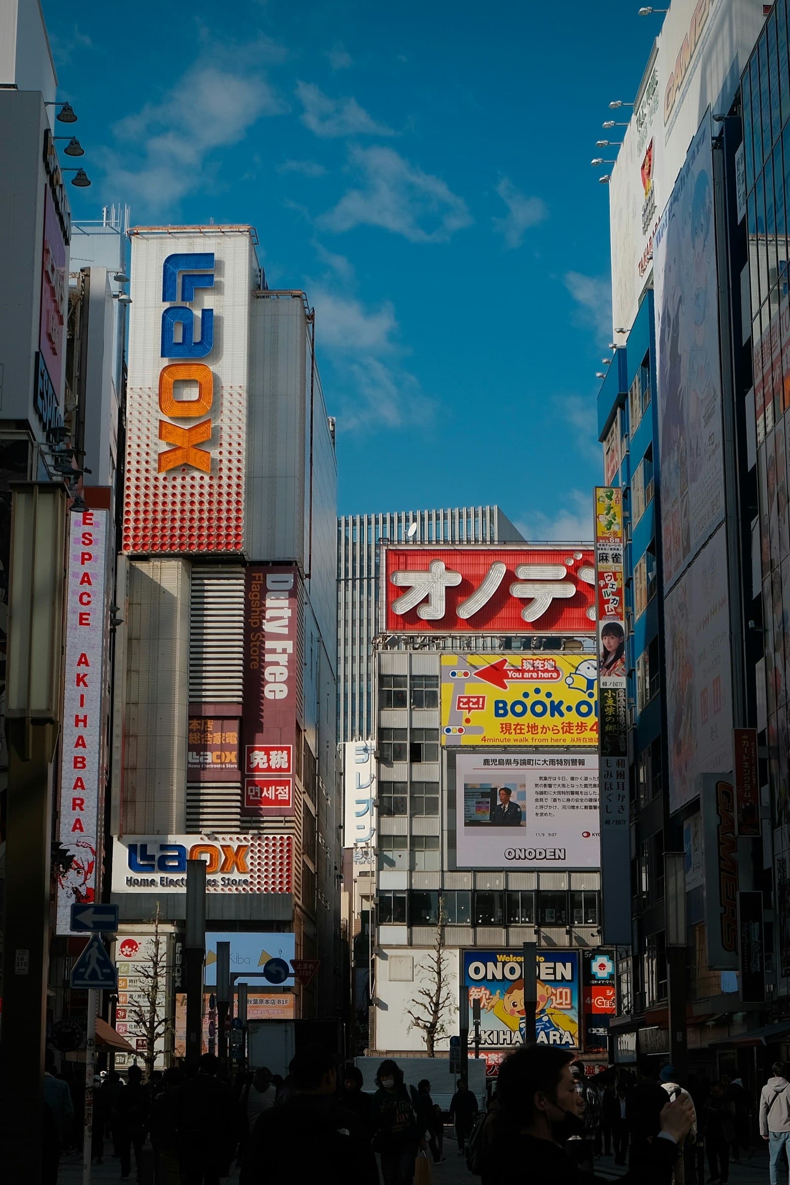 Akihabara, Tokyo, with neon signs and bustling streets