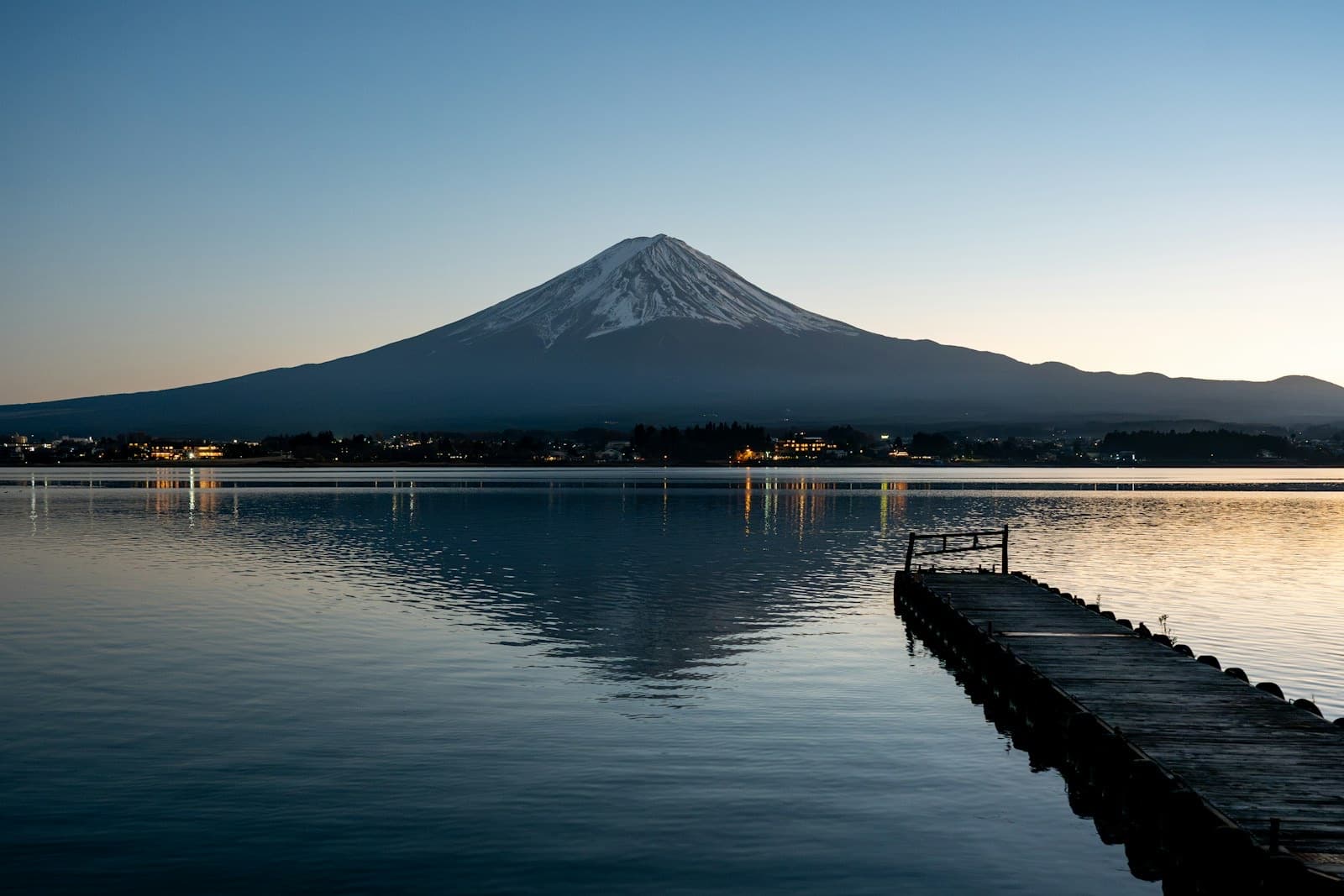Mount Fuji reflected in a calm lake at dawn in Yamanashi Prefecture