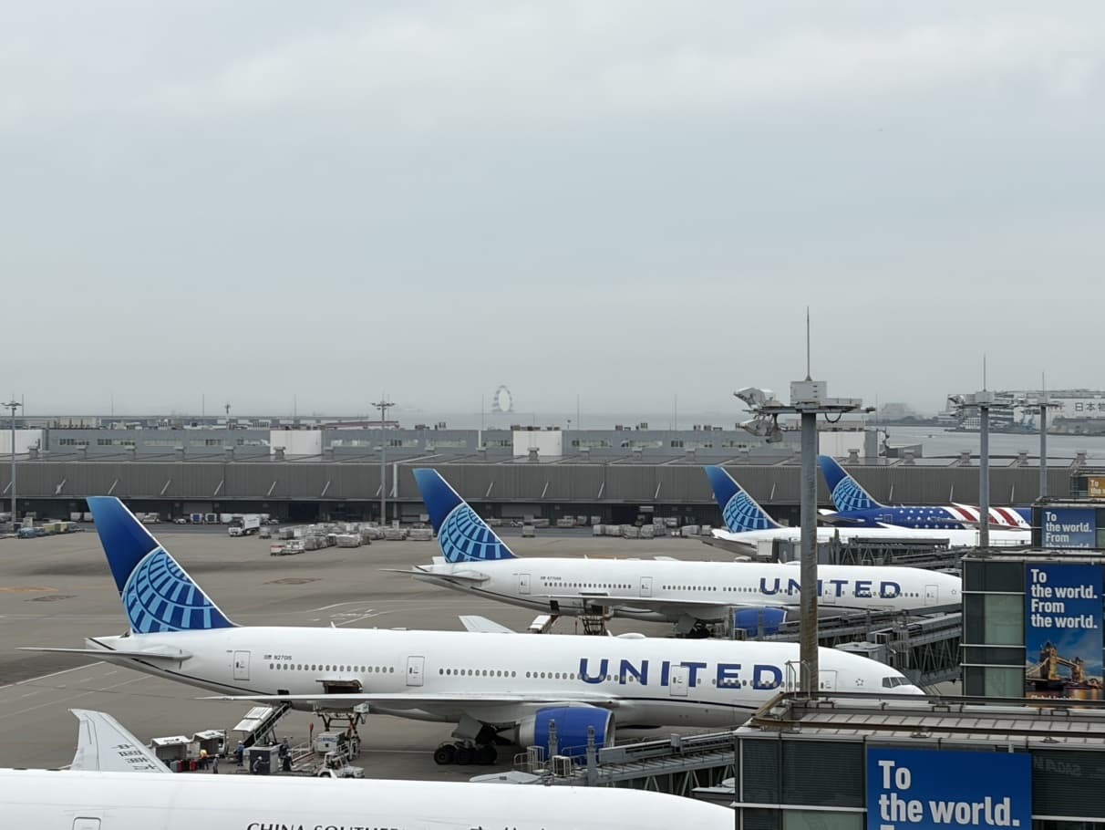 Several United Airlines jets parked at airport gates in Japan