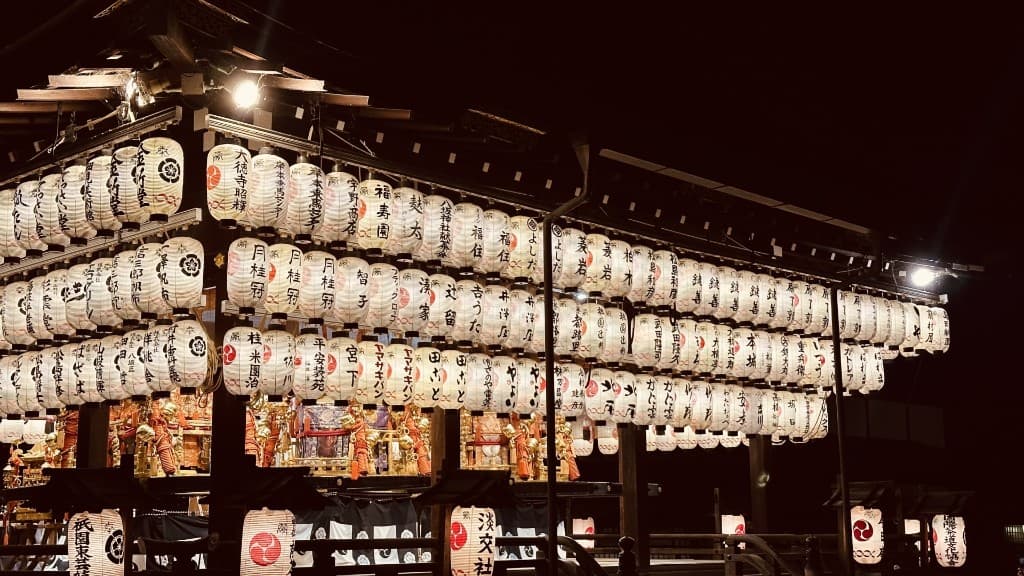 Rows of glowing paper lanterns at Yasaka Shrine during Kyoto's Gion Matsuri at night