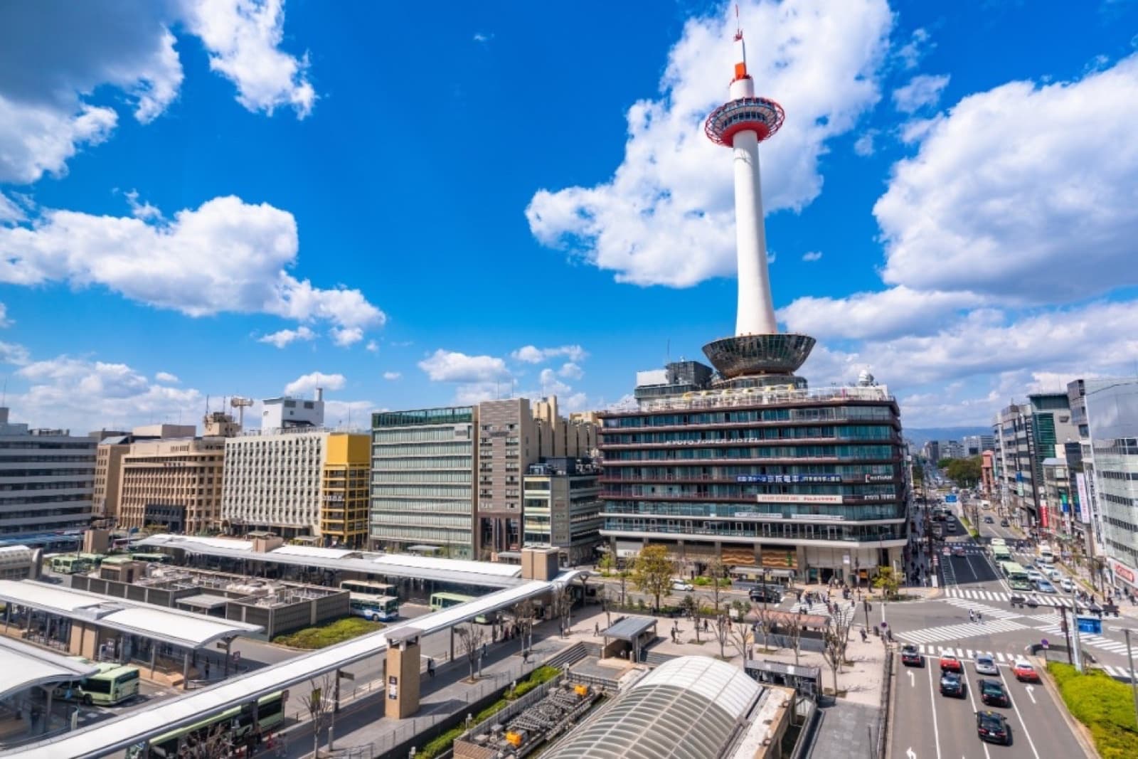 Kyoto Tower and Kyoto Station bus terminal on a clear day