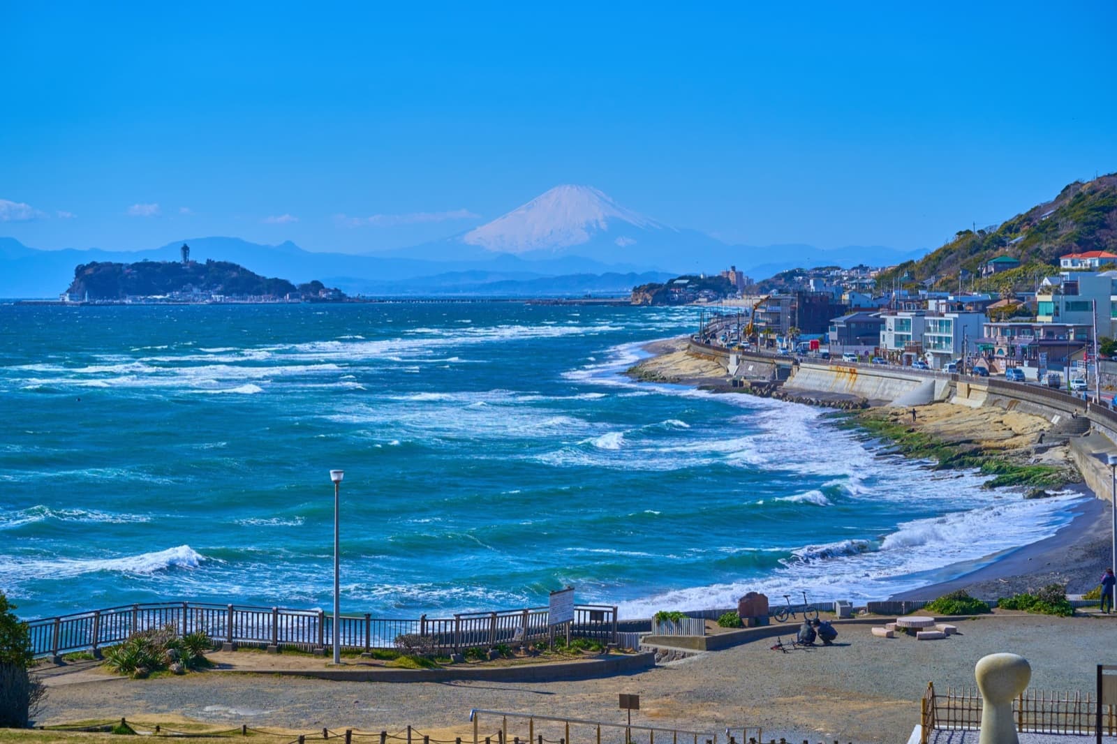 View from Inamuragasaki over Sagami Bay to Enoshima and a snow-capped Mount Fuji on the horizon