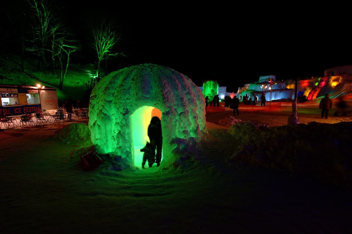 Colored night illumination on the ice domes and towers at the Lake Shikotsu Ice Festival, Hokkaido