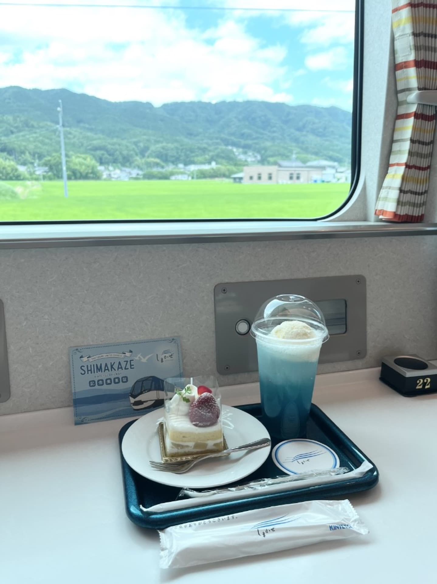 Shimakaze cafe menu: pastel cake from the Sheraton Miyako Hotel pastry chef, blue Shimakaze drink, and a Shimakaze coaster
