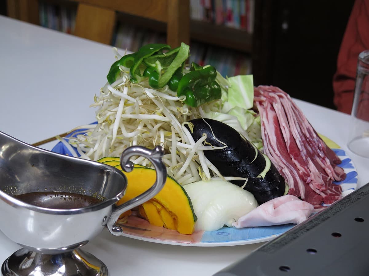 A plate of sliced mutton, bean sprouts, pumpkin, onion and peppers ready for the jingisukan grill