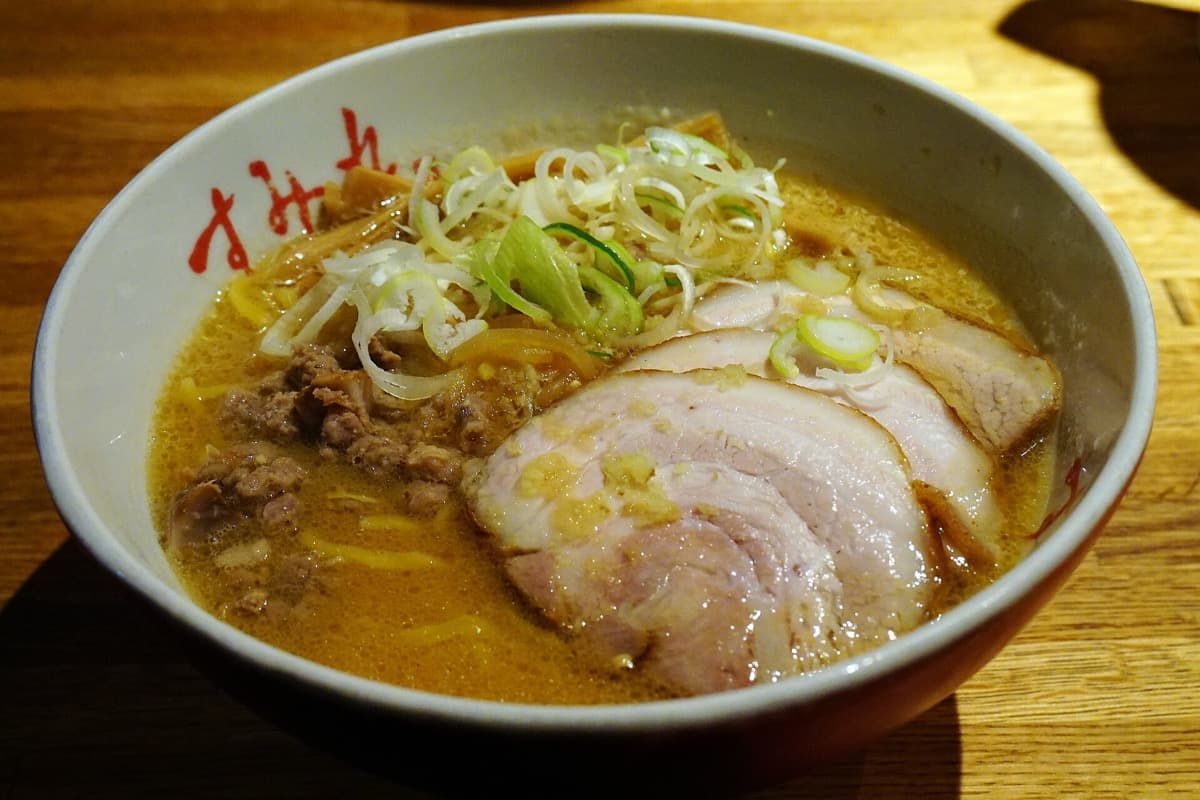 A bowl of Sapporo miso ramen with chashu pork, minced meat and green onions