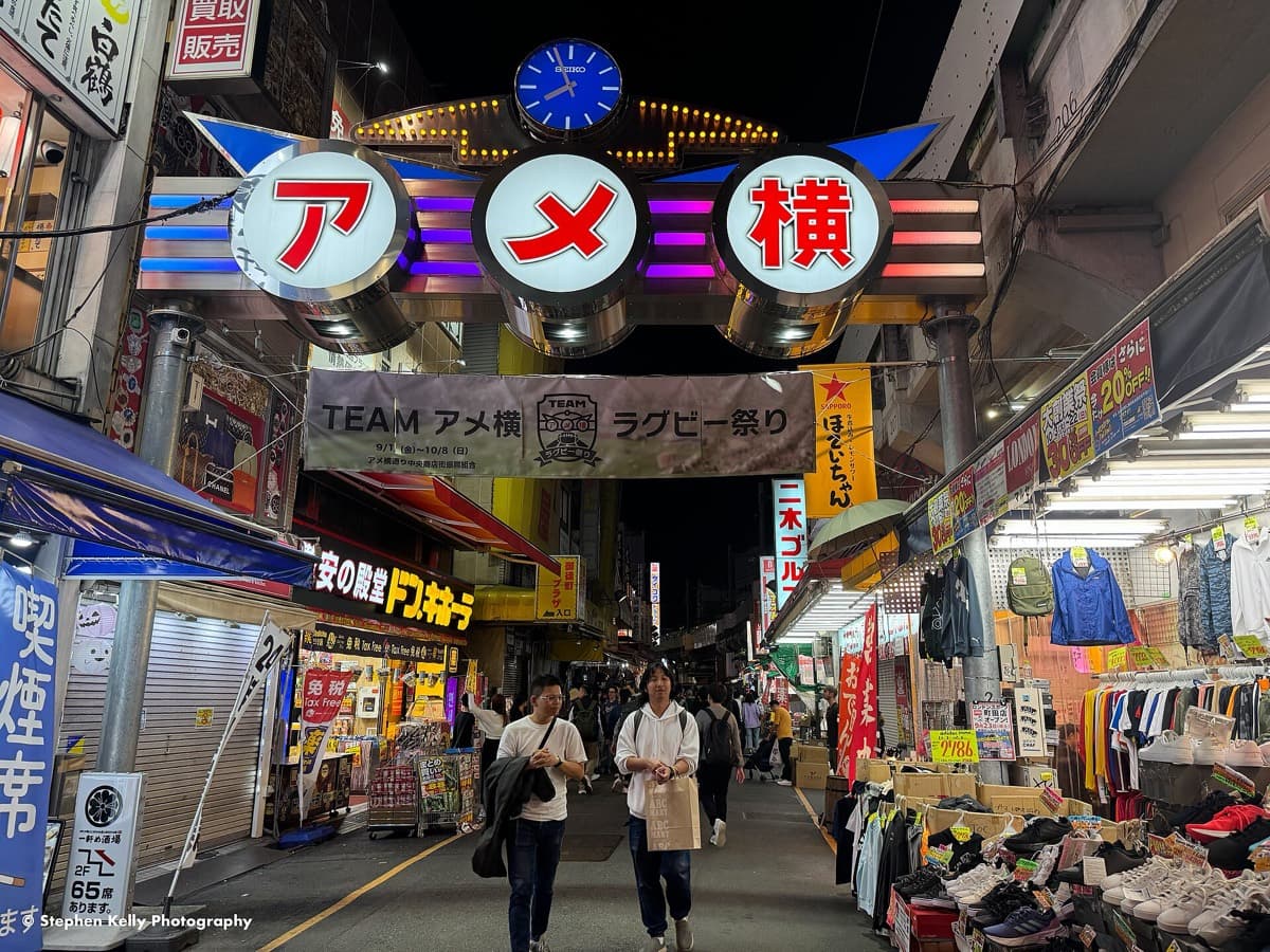 The Ameyoko market street sign above a busy shopping street near Ueno Station
