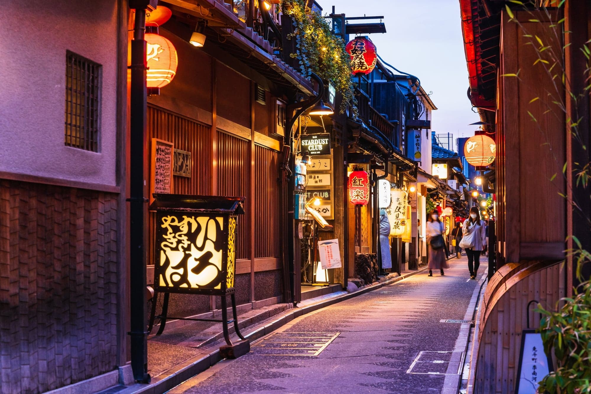 Lanterns lighting the narrow Pontocho alley in Kyoto at dusk