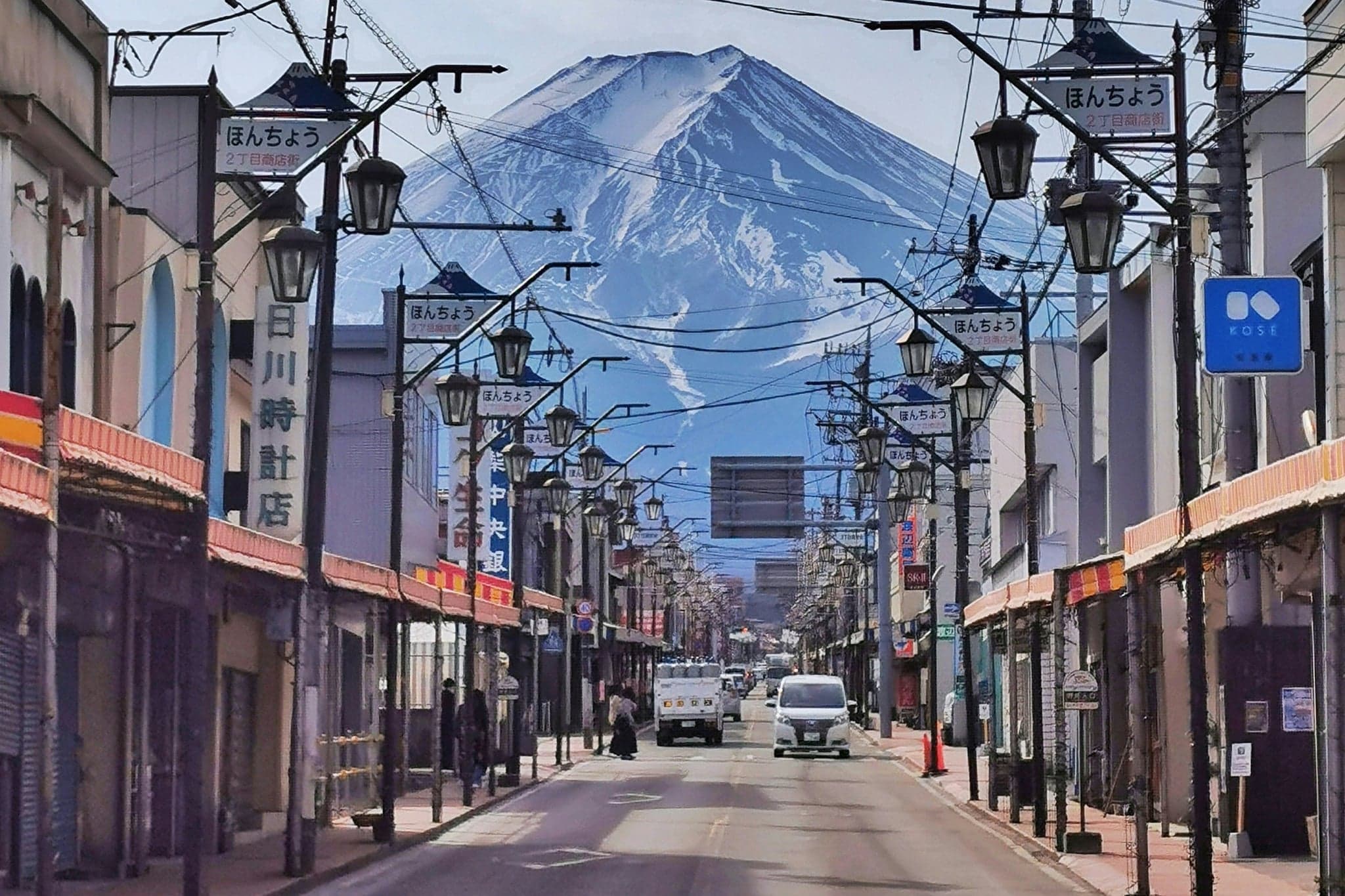 El monte Fuji al fondo de una calle comercial de Fujiyoshida