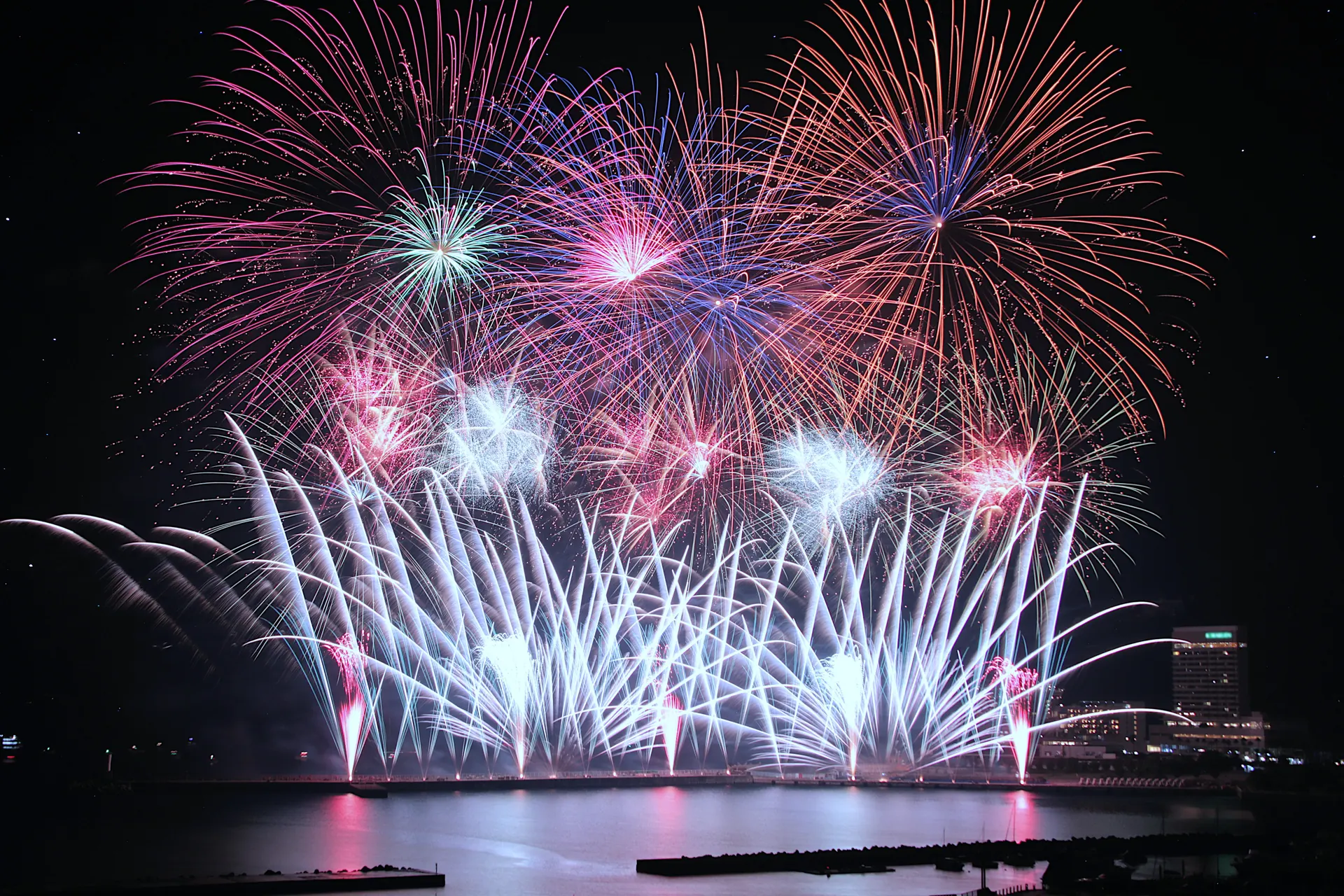 Colorful summer fireworks bursting over the bay at the Atami sea fireworks festival in Shizuoka, Japan